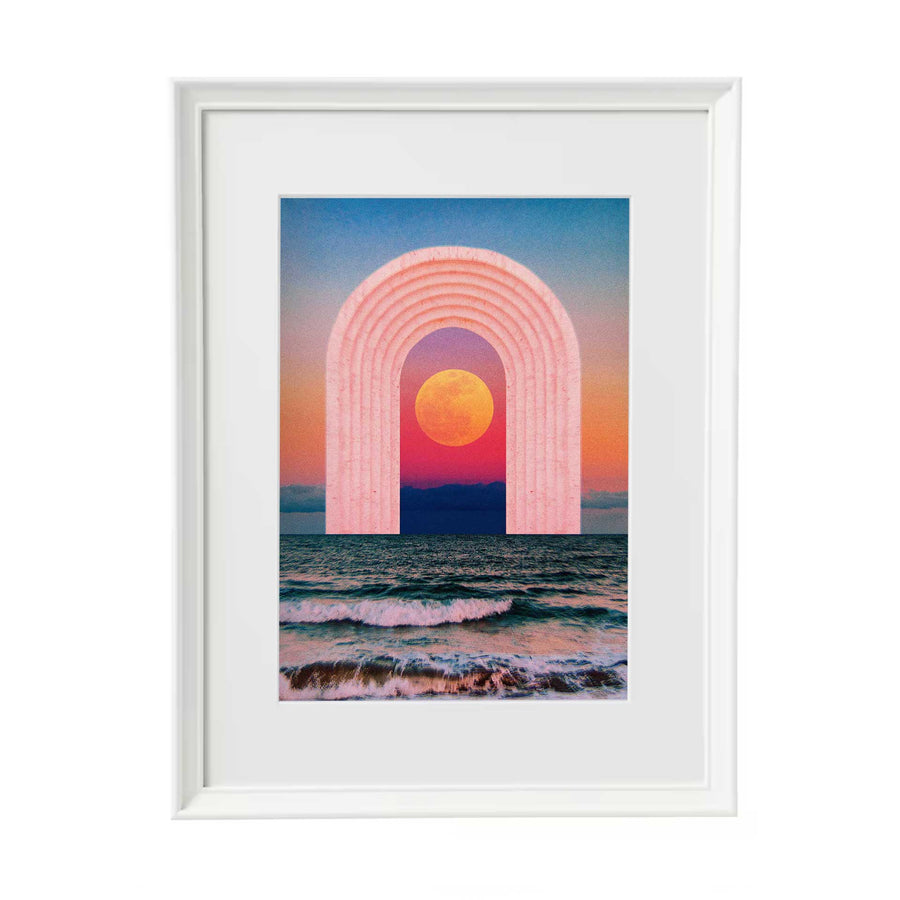 Digital collage print of a pastel pink archway showing a colourful sunset with an orange sun, with waves below. In a white frame with white mount.