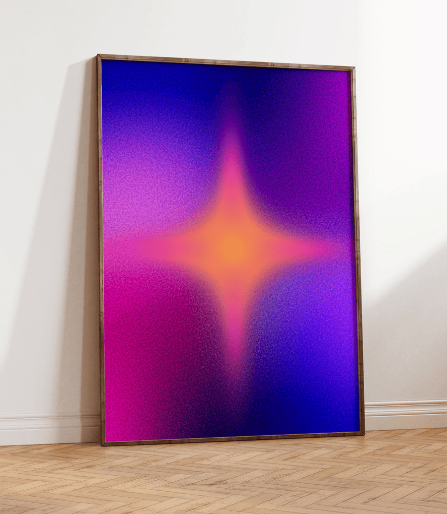 Framed art print of Colourful star aura with a pink and blue gradient background. Frame is thin dark wood and is on a wooden floor, resting against a white wall.