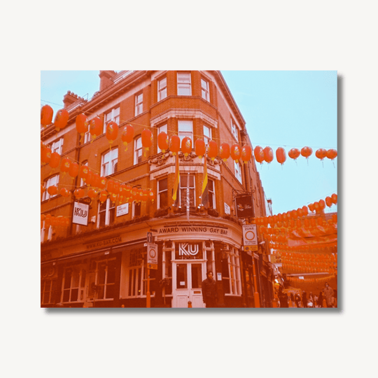 Film photograph with a red hue to it of a Chinese Gay bar in London Soho.