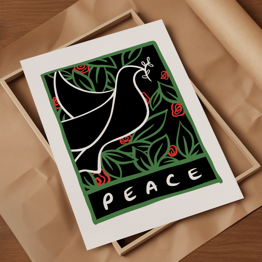 A digital illustration of a white line drawing of a dove with an olive branch, surrounded by green leaves and red flowers with the word 'Peace' at the bottom. The art print is laid on top of a picture frame, resting on brown parcel paper.