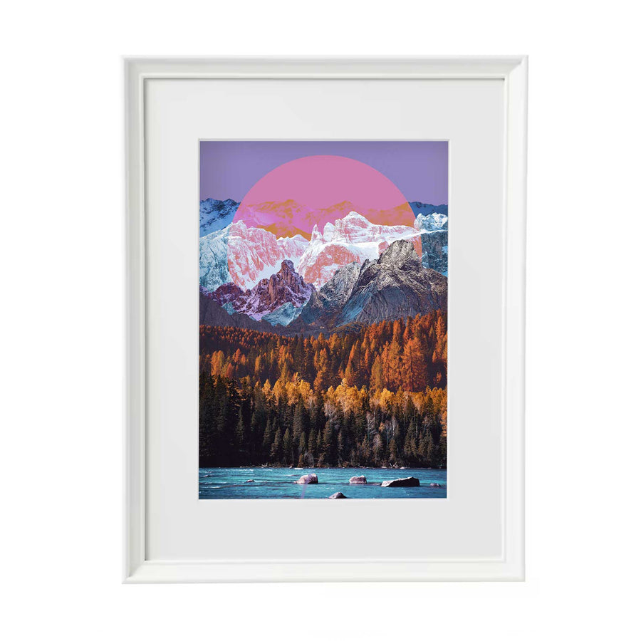 Digital collage print of mixed landscapes, featuring a lake with rocks at the bottom, a dense forest, snow topped mountains with a pink/purple circle and a purple sky. In a white frame with white mount.