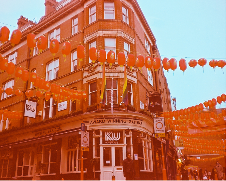 Film photograph with a red hue to it of a Chinese Gay bar in London Soho.