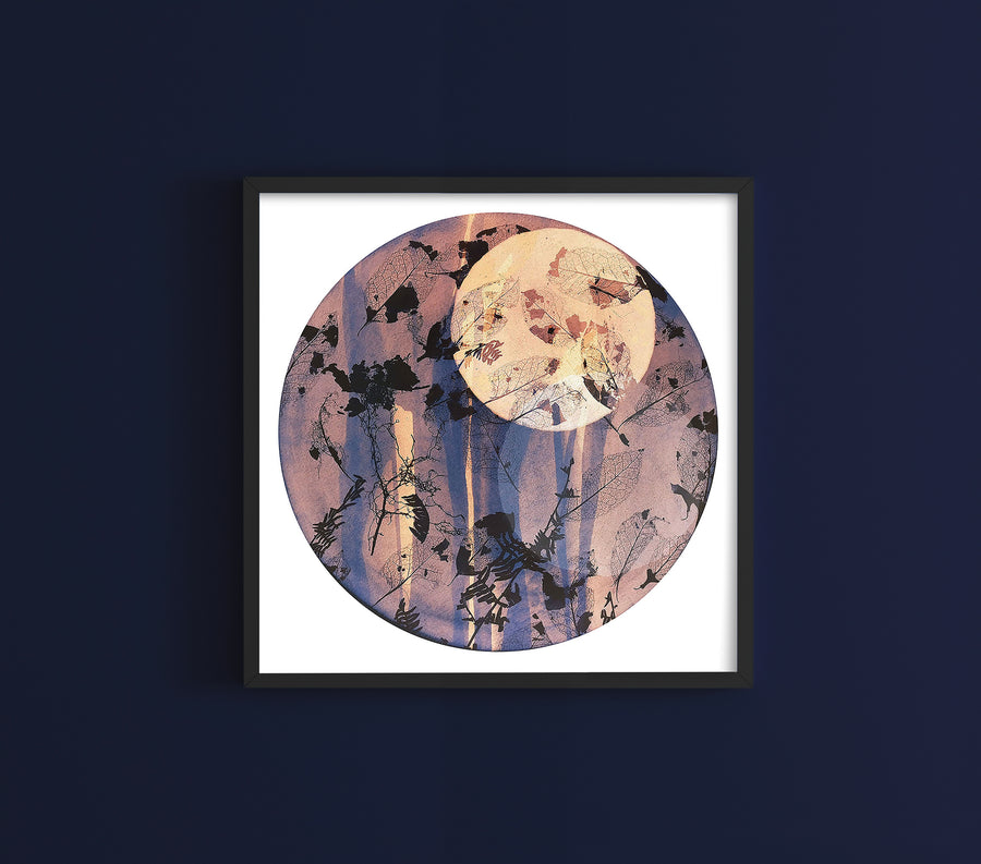 Square framed wall art on navy wall showing a dusty purple, lilac, pink and peach cyanotype print. The cyanotype itself is circle shaped art but in a square frame.