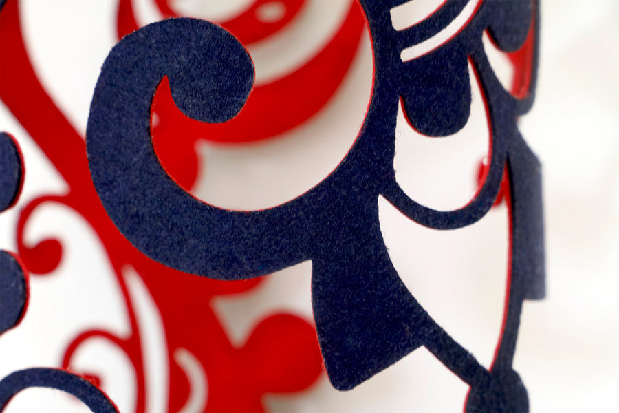 Close up showing the intricate design on this navy and red textile and glass sculpture by Jennifa Chowdhury, inspired by the female ‘Vrata’ rituals.