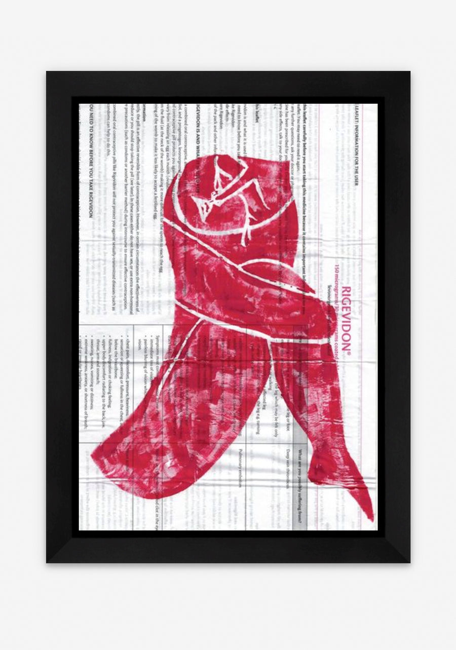 Lino print of a woman crying in red acrylic paint on a ‘Rigevidon’ contraceptive pill leaflet, in a black frame.